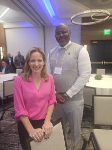Chuck Grigsby poses for a photo with Secretary of State Jocelyn Benson.